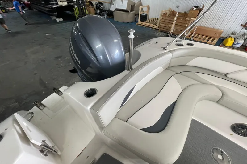 Slide: The Image of 2016 Starcraft Coastal 2009 OB boat interior with Yamaha outboard motor in a garage. - 13