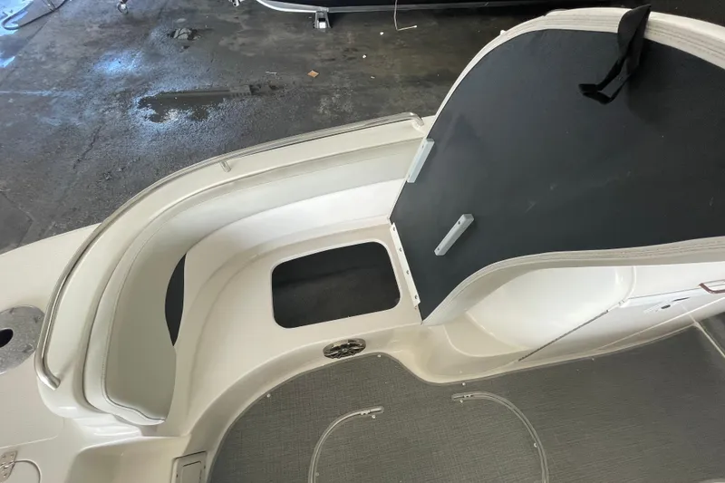 Slide: The Image of Interior view of 2016 Starcraft Coastal 2009 OB boat, featuring seating and storage area. - 20