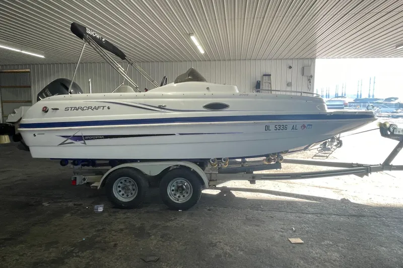Slide: The Image of 2016 Starcraft Coastal 2009 OB boat on trailer in indoor storage. - 23
