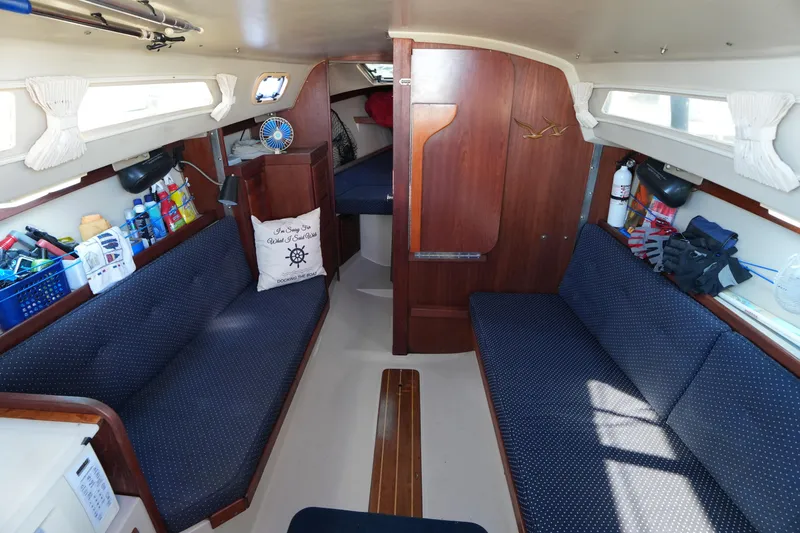 Slide: The Image of Interior of a 1988 Catalina 27 sailboat with cozy seating and nautical decor. - 12