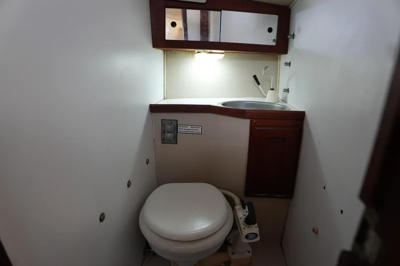 Slide: The Image of Compact bathroom in a 1988 Catalina 27 sailboat with toilet and sink. - 15