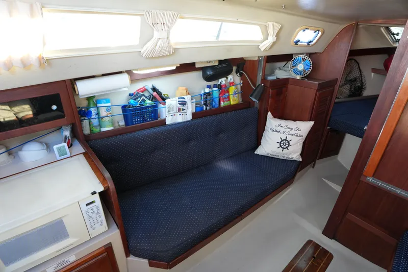 Slide: The Image of Interior of a 1988 Catalina 27 sailboat with cozy seating and nautical decor. - 17