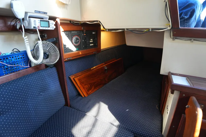 Slide: The Image of Interior of a 1988 Catalina 27 sailboat with navigation equipment and cozy seating. - 19