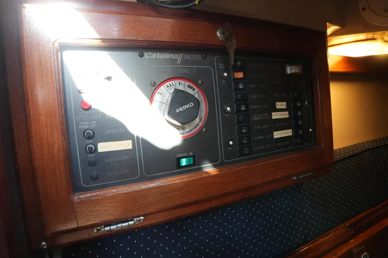 Slide: The Image of Control panel of a 1988 Catalina 27 sailboat with various switches and dials. - 20