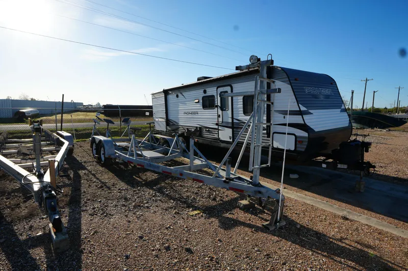 Slide: The Image of Trailer parked on gravel lot beside a Catalina 27, 1988 model. - 22