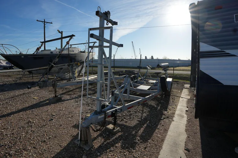 Slide: The Image of 1988 Catalina 27 sailboat on trailer in sunny boatyard. - 23