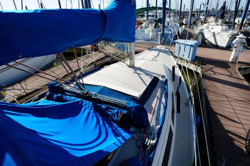 Slide: The Image of 1988 Catalina 27 sailboat docked at marina with blue sail cover. - 5