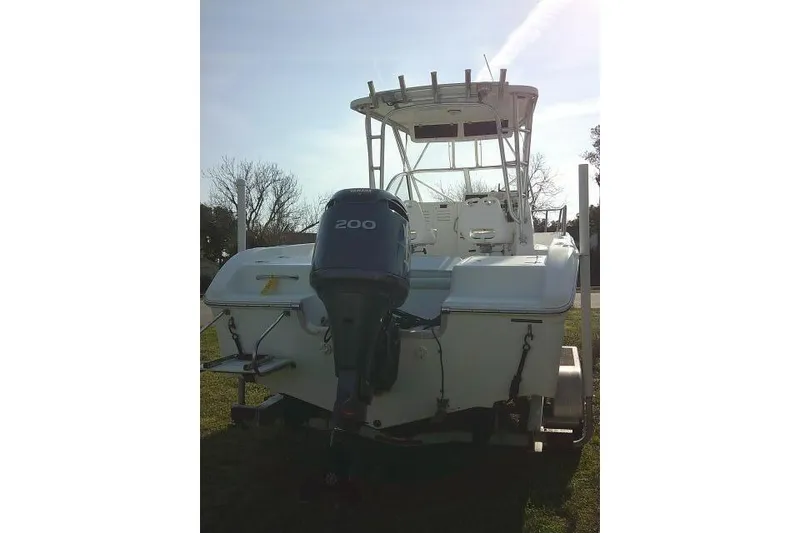 Slide: The Image of 2005 Sea Pro boat with 200 horsepower outboard motor, parked on grass. - 10