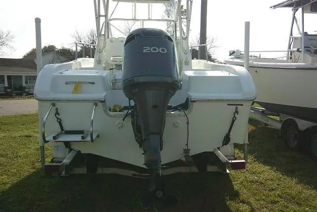 Slide: The Image of 2005 Sea Pro boat with 200 horsepower outboard motor, parked on grass. - 11