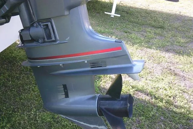 Slide: The Image of 2005 Sea Pro boat motor with propeller on grassy background. - 14