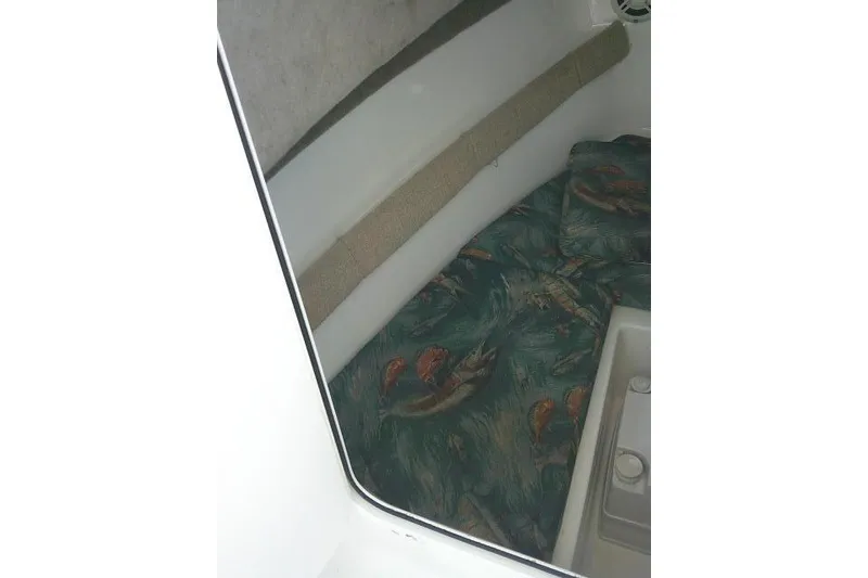 Slide: The Image of 2005 Sea Pro boat interior with patterned cushions and storage compartment. - 22