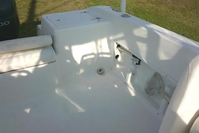 Slide: The Image of 2005 Sea Pro boat interior with white seating and storage compartments. - 26