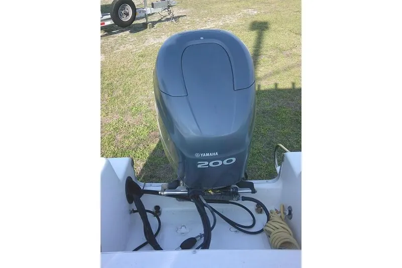 Slide: The Image of Yamaha 200 outboard motor on 2005 Sea Pro boat, parked on grass. - 27