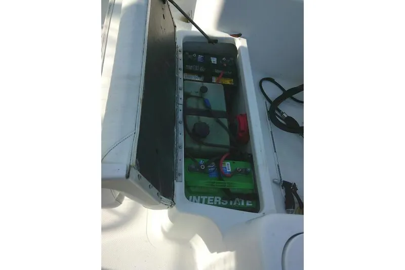 Slide: The Image of 2005 Sea Pro boat battery compartment with Interstate battery and tools. - 31
