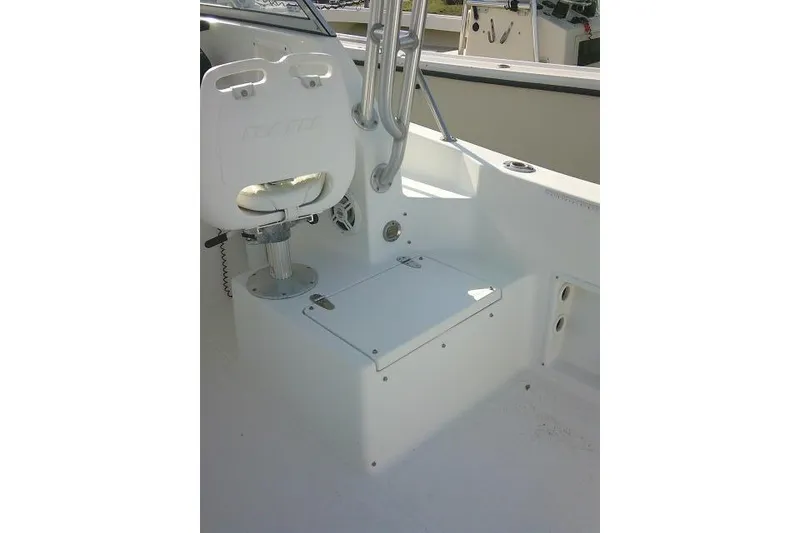 Slide: The Image of 2005 Sea Pro boat interior with white seating and storage compartment. - 32
