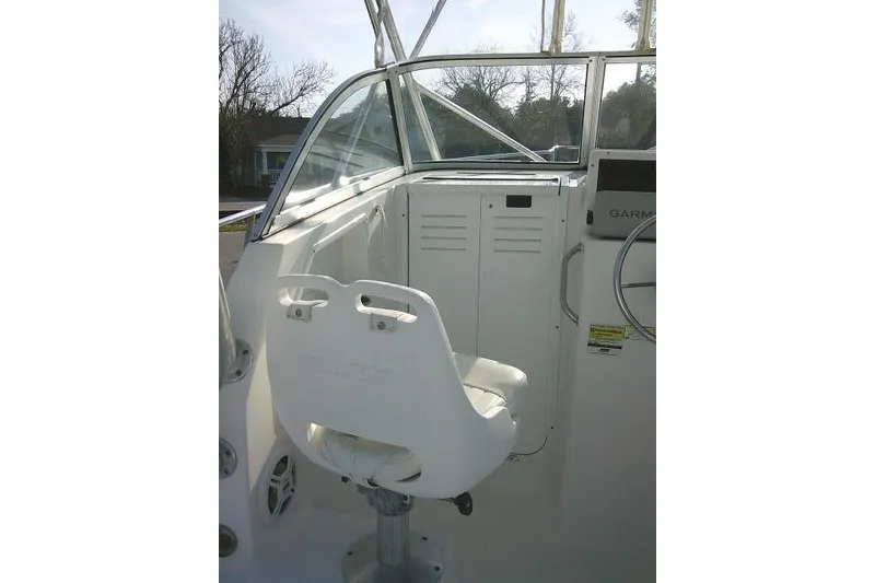 Slide: The Image of 2005 Sea Pro boat interior with white captain's chair and control panel. - 34