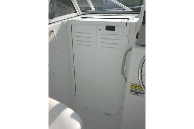 Slide: The Image of 2005 Sea Pro boat interior with white storage compartment and steering wheel. - 40