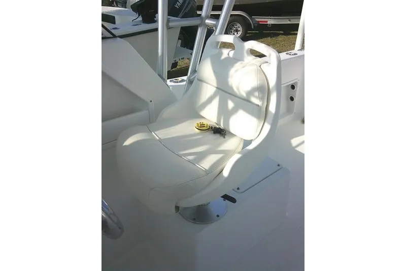Slide: The Image of 2005 Sea Pro boat seat with white upholstery and accessories on deck. - 42