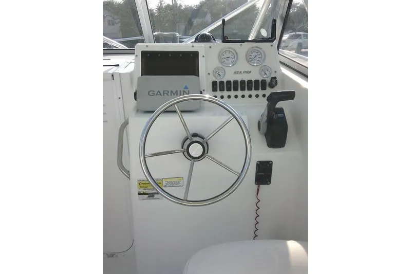Slide: The Image of 2005 Sea Pro boat dashboard with Garmin GPS and steering wheel. - 43