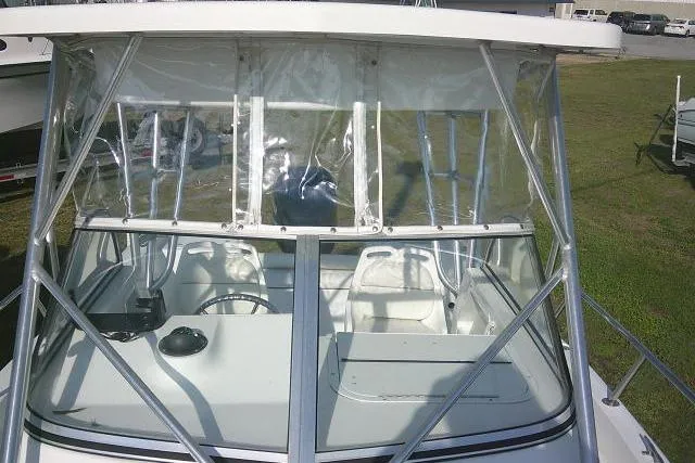 Slide: The Image of 2005 Sea Pro boat with clear windshield and metal frame, parked on grass. - 49