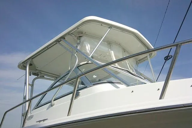 Slide: The Image of 2005 Sea Pro boat with white hardtop and stainless steel railings against blue sky. - 5