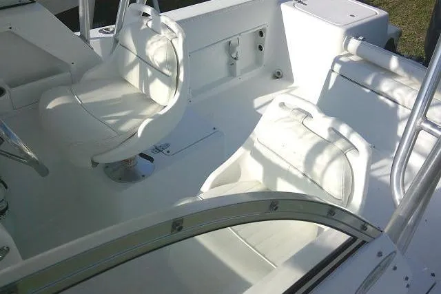 Slide: The Image of 2005 Sea Pro boat interior with white seating and steering area. - 50