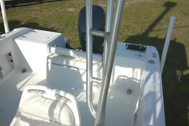 Slide: The Image of 2005 Sea Pro boat interior with seating and railing, parked on grass. - 51