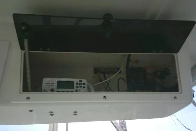Slide: The Image of 2005 Sea Pro boat electronics compartment with radio and wiring. - 52