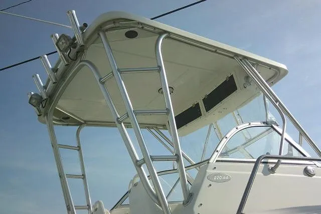 Slide: The Image of 2005 Sea Pro boat with sturdy metal framework and sleek design against a clear sky. - 8