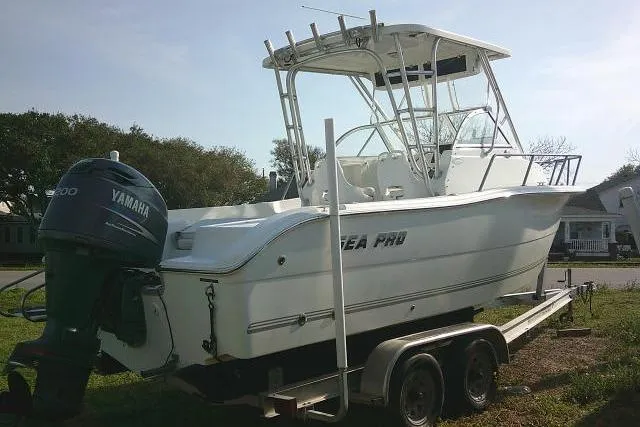 Slide: The Image of 2005 Sea Pro boat on trailer with Yamaha outboard motor, parked on grass. - 9