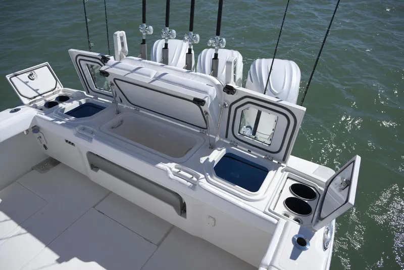 Slide: The Image of 2025 Solace 37 CS boat with open storage compartments and fishing rod holders. - 15