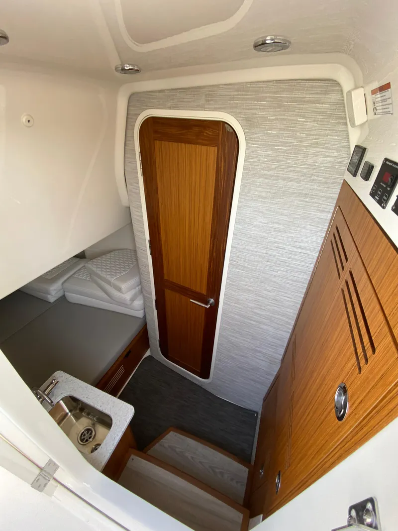 Slide: The Image of Interior cabin of 2025 Solace 37 CS boat with wooden door and compact amenities. - 18