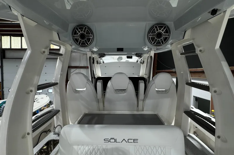 Slide: The Image of Interior view of 2025 Solace 37CS boat with seating and speakers. - 23