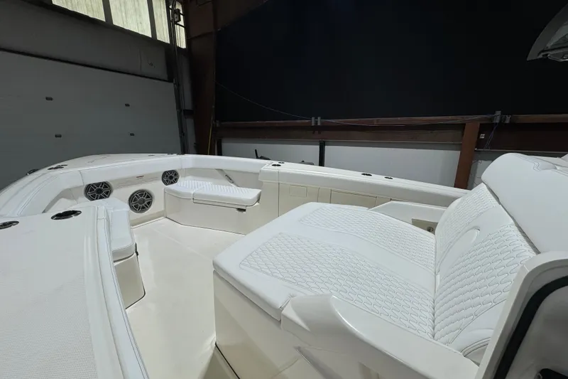 Slide: The Image of Luxurious interior of 2025 Solace 37CS boat with white seating and speakers. - 26