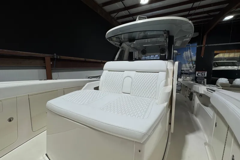 Slide: The Image of 2025 Solace 37CS boat interior with luxurious white seating in a showroom. - 27