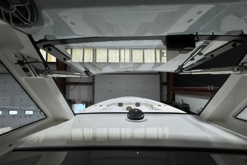 Slide: The Image of Interior view of 2025 Solace 37CS boat, showcasing windshield and hatch mechanisms. - 35