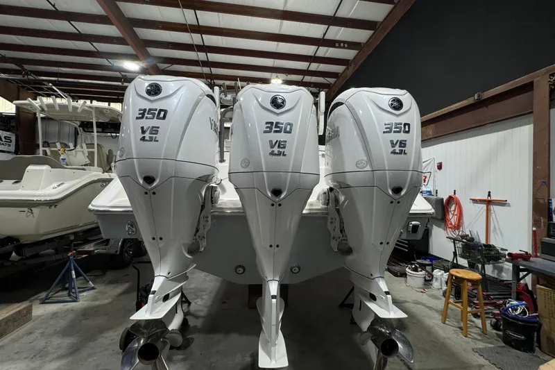 Slide: The Image of 2025 Solace 37CS boat with triple 350 V6 4.2L engines in a garage setting. - 36