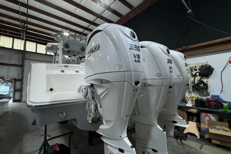 Slide: The Image of 2025 Solace 37CS boat with triple Yamaha 350 V8 engines in a workshop. - 37