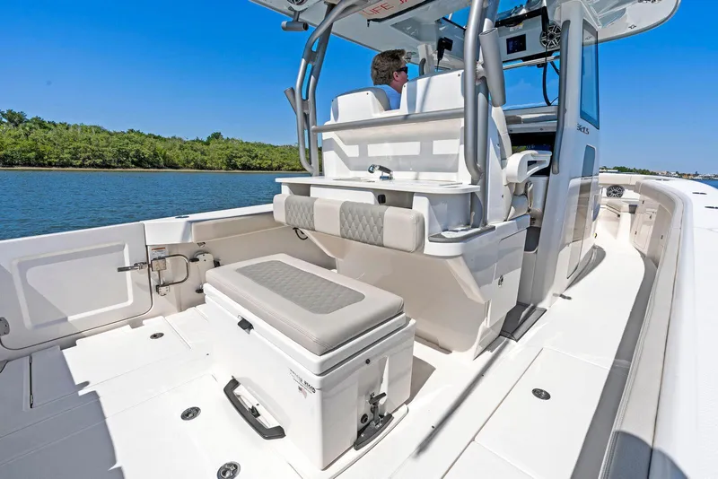 Slide: The Image of 2025 Solace 32 CS boat interior with seating and storage, cruising on a sunny day. - 2