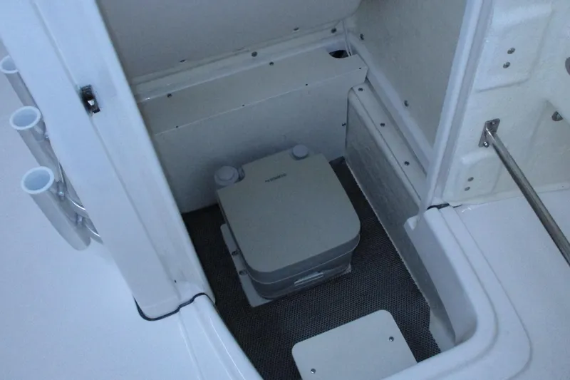 Slide: The Image of 2021 Robalo R180 Center Console boat interior with portable toilet. - 10