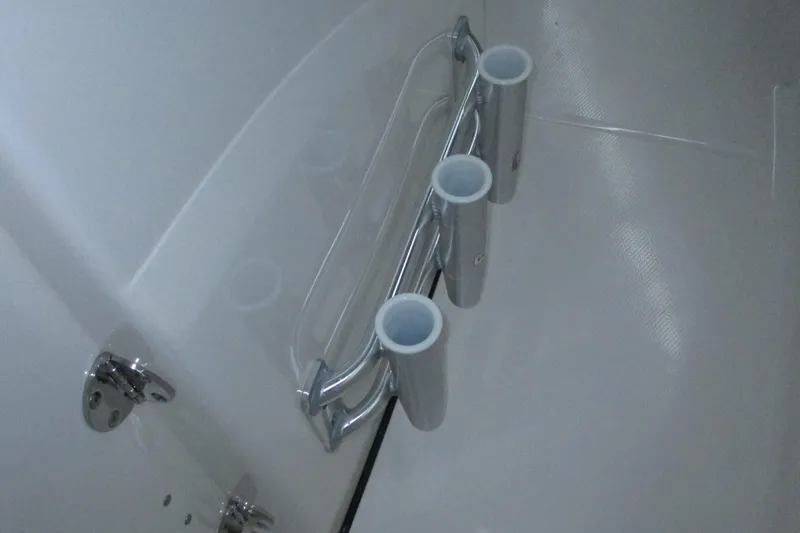 Slide: The Image of 2021 Robalo R180 Center Console rod holders on sleek white interior. - 11