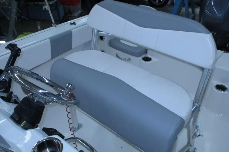 Slide: The Image of 2021 Robalo R180 Center Console boat interior with steering wheel and seating. - 12