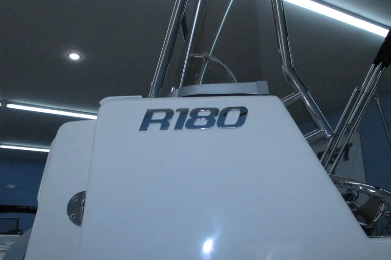 Slide: The Image of 2021 Robalo R180 Center Console boat with sleek design and modern features. - 14