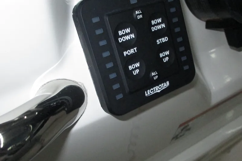 Slide: The Image of Control panel of a 2021 Robalo R180 Center Console boat with Lectrotab trim tab switches. - 15