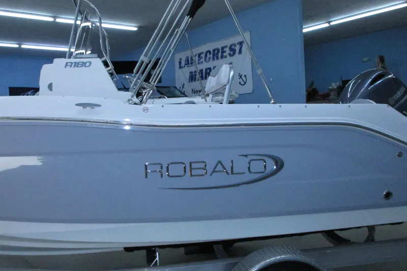 Slide: The Image of 2021 Robalo R180 Center Console boat in showroom, side view. - 3