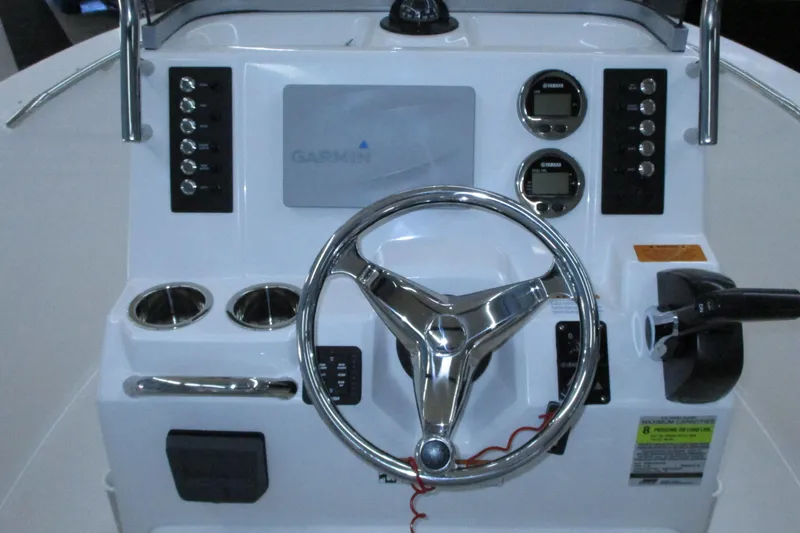 Slide: The Image of 2021 Robalo R180 Center Console dashboard with Garmin display and steering wheel. - 6