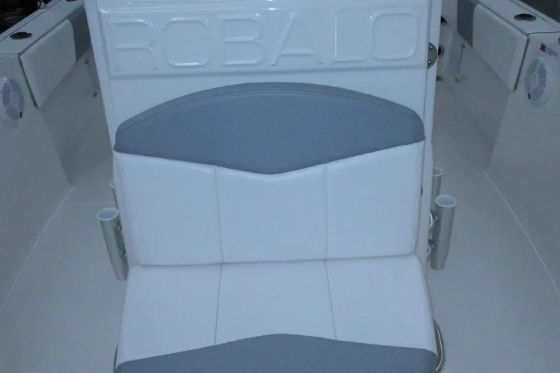 Slide: The Image of 2021 Robalo R180 Center Console boat seat with embossed logo and cup holders. - 9