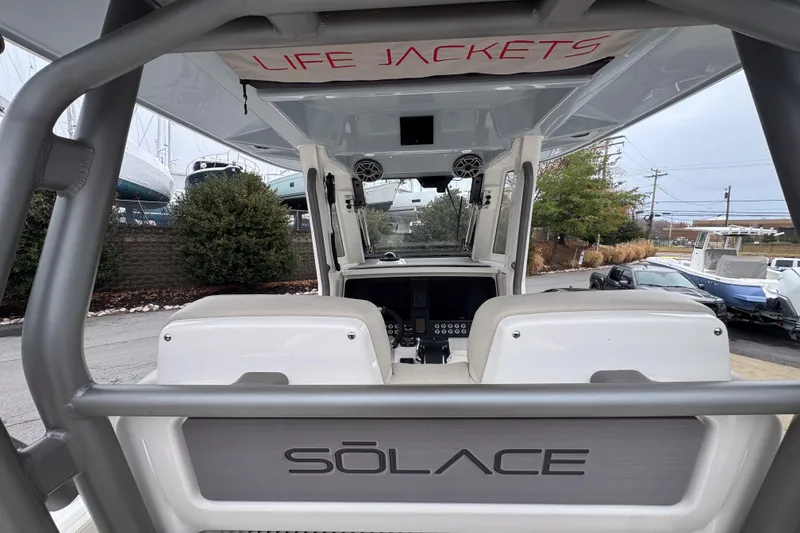 Slide: The Image of 2025 Solace 30 HCS boat interior with life jackets storage and control panel. - 10