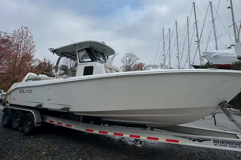 Slide: The Image of 2025 Solace 30 HCS boat on trailer, surrounded by trees and sailboats. - 3