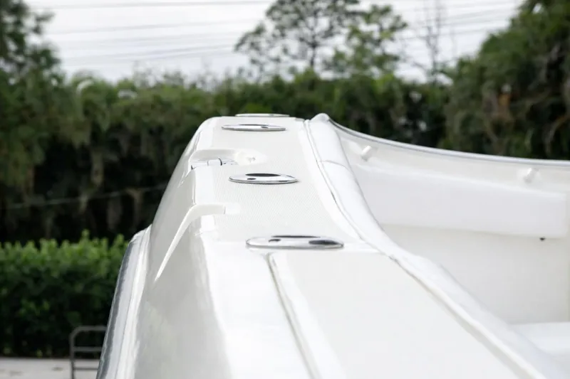 Slide: The Image of 2008 Hydra-Sports Vector 2900 CC boat deck with rod holders, lush greenery background. - 31